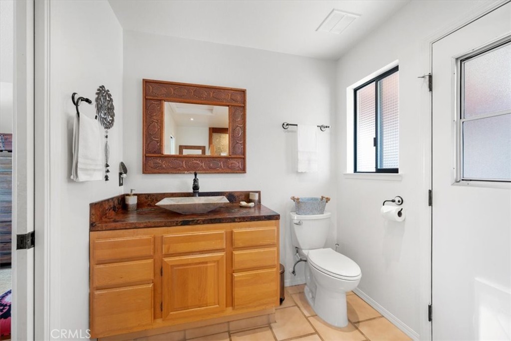 9750 Random Canyon Way Creston, CA 93432 - Photo 29 of 73 a bathroom with a toilet sink and mirror