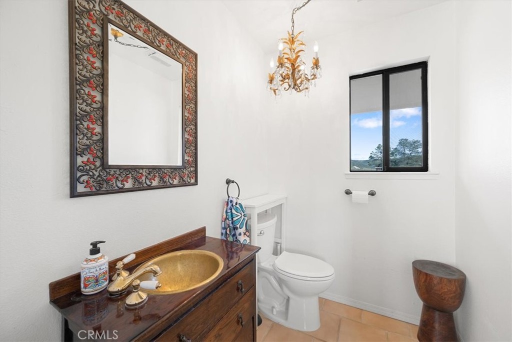 9750 Random Canyon Way Creston, CA 93432 - Photo 43 of 73 a bathroom with a sink mirror vanity and toilet