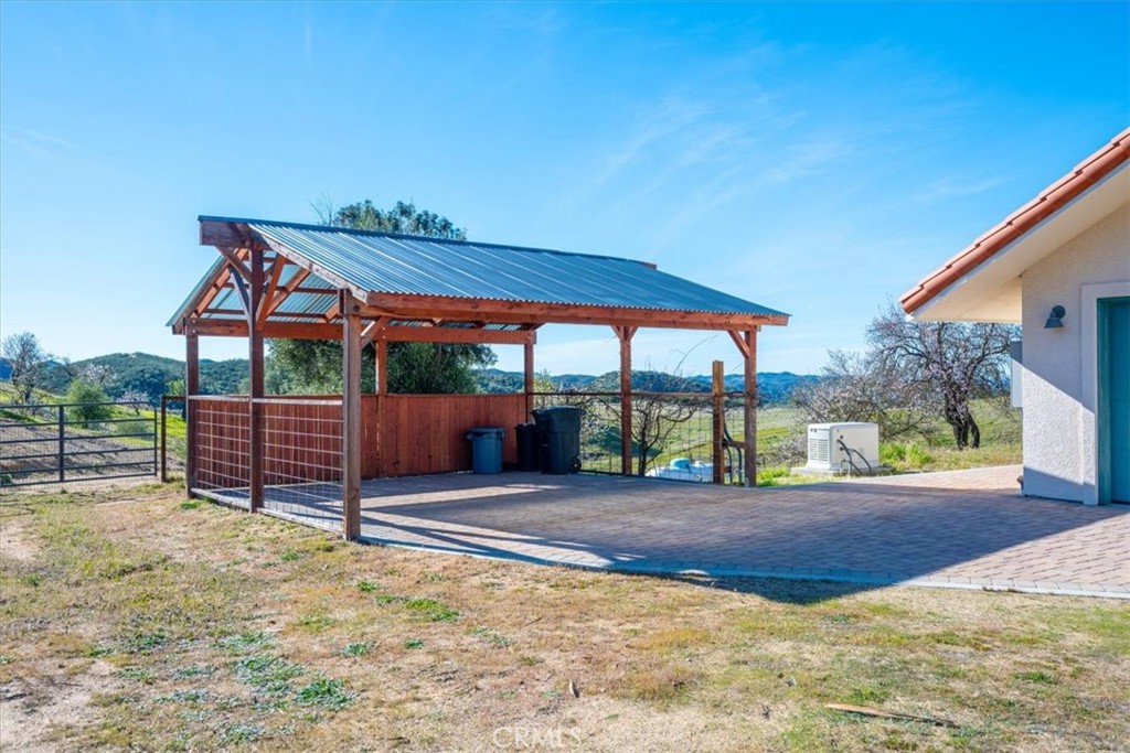 9750 Random Canyon Way Creston, CA 93432 - Photo 6 of 73 a view of a patio with a table and chairs under an umbrella