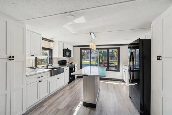 a kitchen with stainless steel appliances a stove microwave and sink