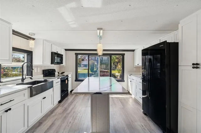a kitchen with a stove a sink and a microwave