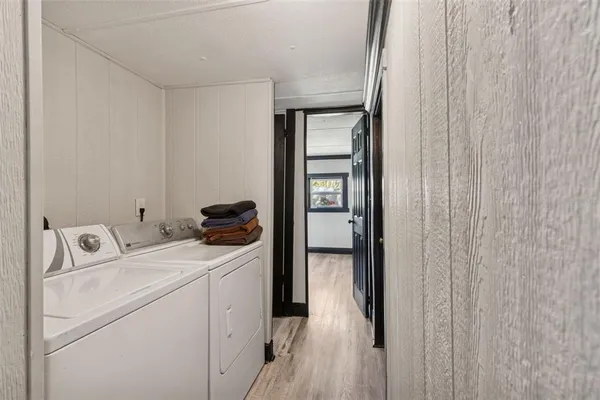 a spacious bathroom with a double vanity sink a mirror and a bathtub
