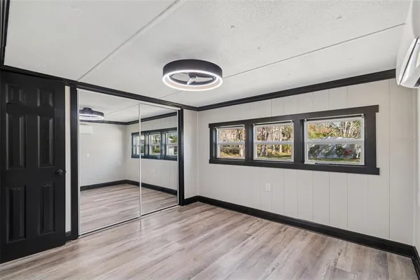 a hall with a sink and a mirror