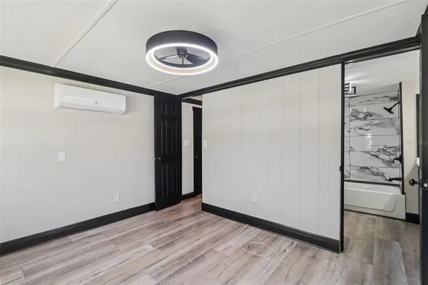 a view of an empty room and wooden floor