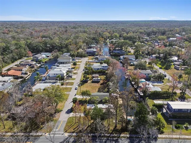 an aerial view of a house with a yard basket ball court and outdoor seating