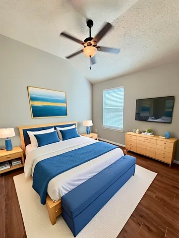 a bedroom with bed and a flat screen tv