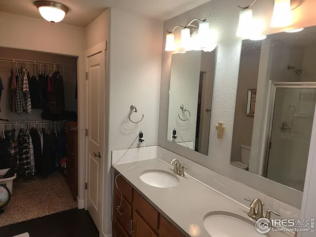 a bathroom with a double vanity sink and a mirror