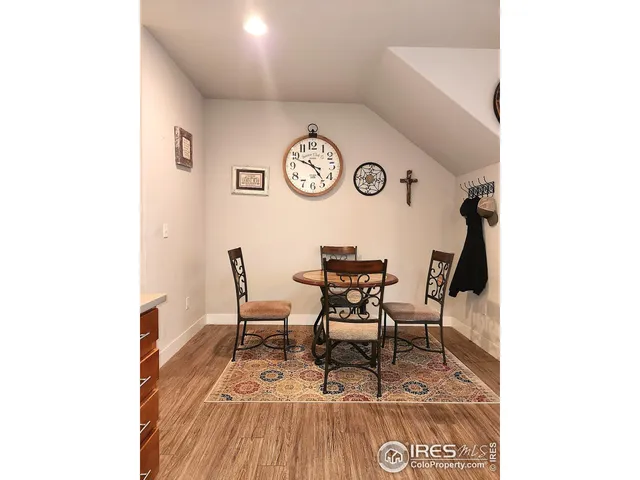 a view of a room with a dining table and chairs