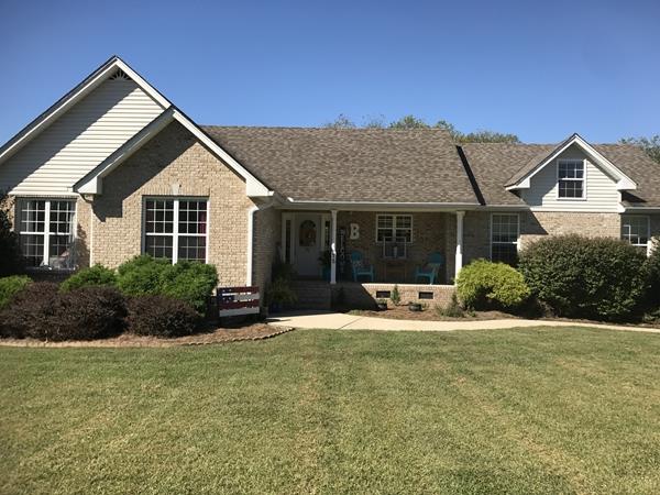 a front view of a house with a yard and porch