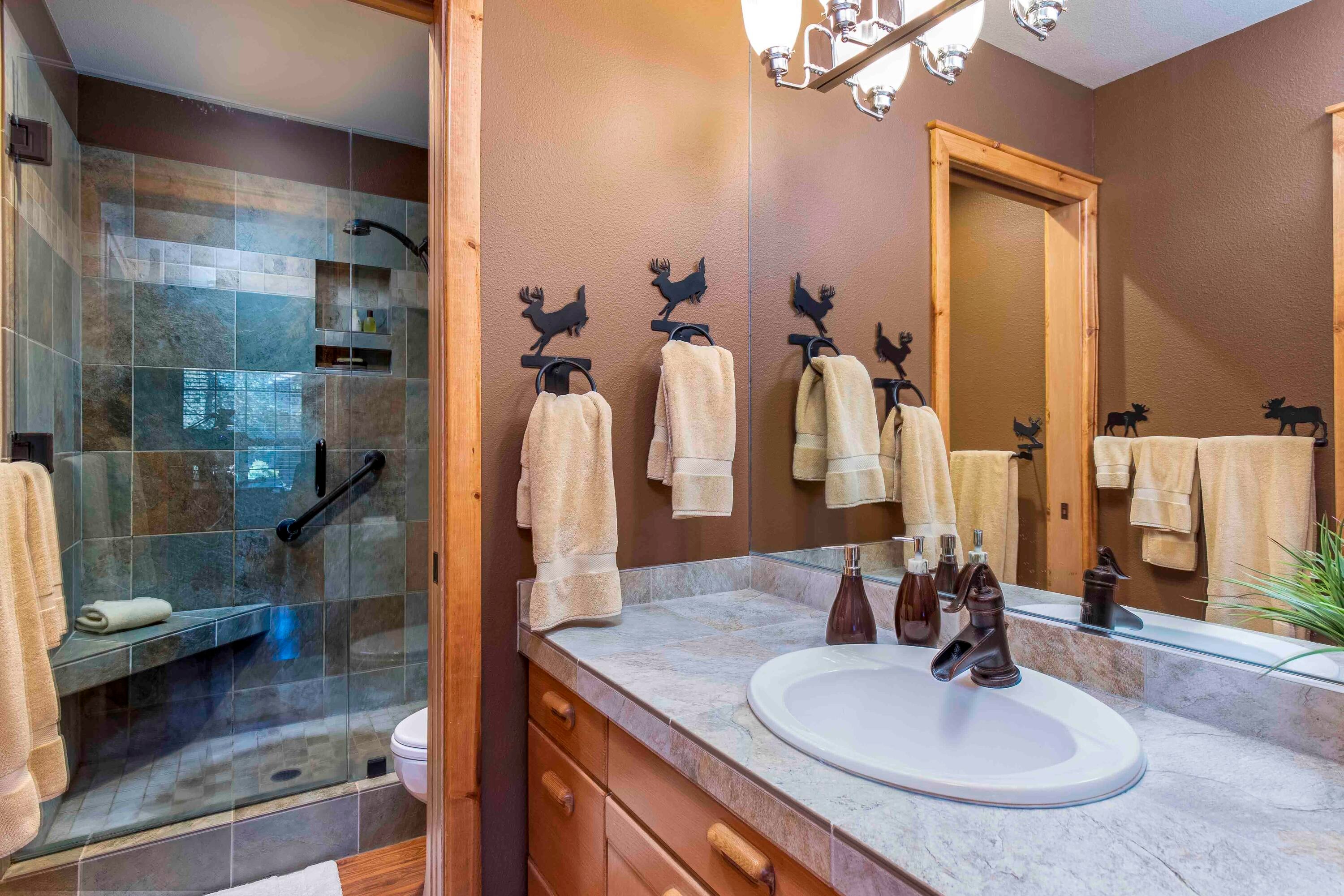 17912 Rhododendron Lane Sunriver, OR 97707 - Photo 25 of 35 Off the family room area, this bathroom offers a tiled shower and enclosed facilities.