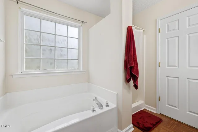 a bathroom with a bathtub and shower