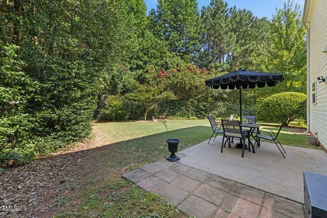 a view of a table and chairs under an umbrella
