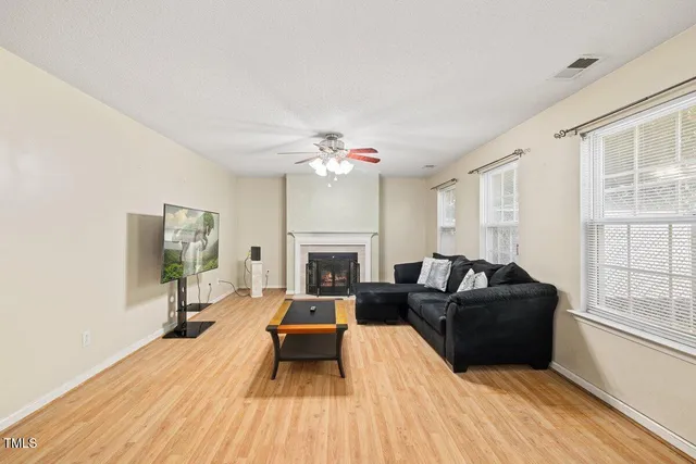 a living room with furniture and a fireplace