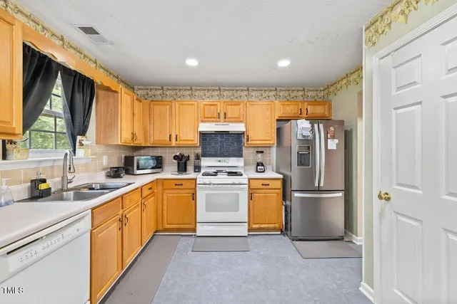 a kitchen with a refrigerator and a sink