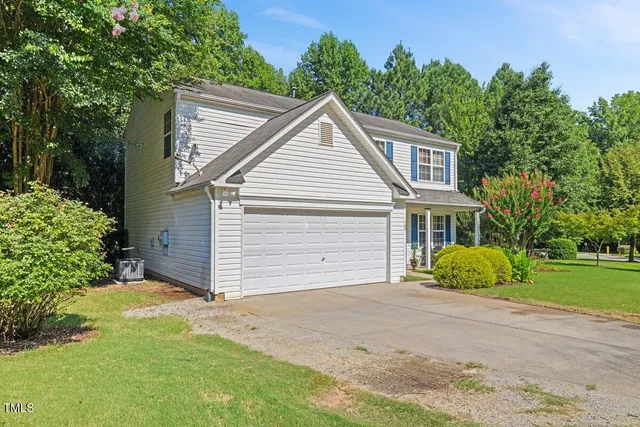 a view of a house with a yard and garage