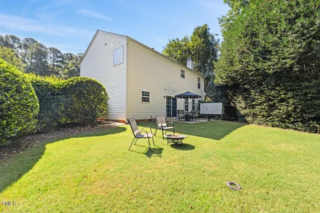 a swimming pool with outdoor seating and yard