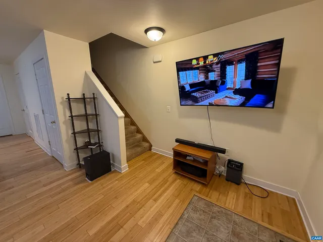 a view of entryway and hall with wooden floor