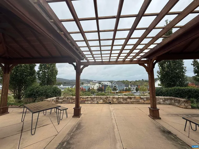a view of a porch with chairs and backyard