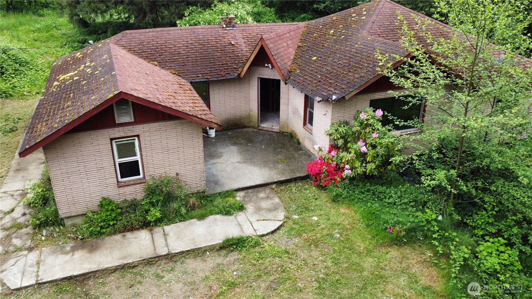 10379 Bethel Burley Road Southeast Port Orchard, WA 98367 - Photo 2 of 40 a aerial view of a house with table and chairs in a yard