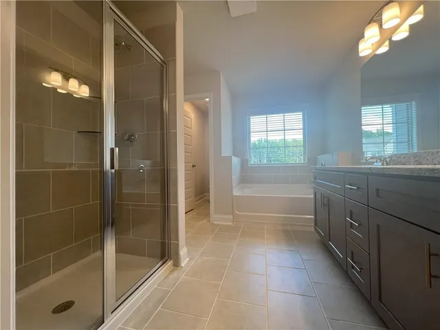 a bathroom with a shower a sink and a mirror
