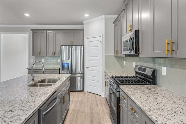 a kitchen with granite countertop stainless steel appliances and granite counter tops