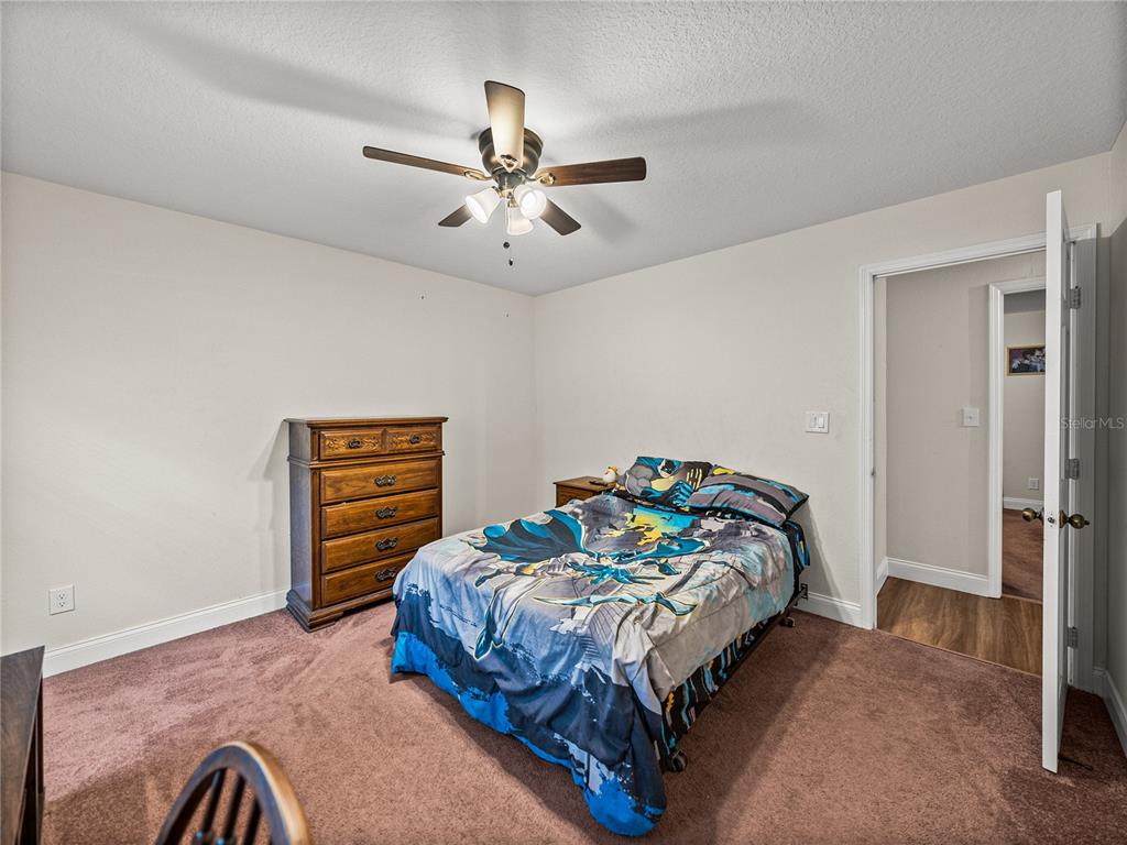 609 West Pipkin Road Lakeland, FL 33813 - Photo 34 of 72 a bedroom with a bed and a chandelier