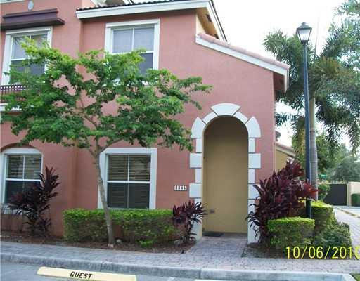 3345 Merrick Lane, Unit 1101 Margate, FL 33063 - Photo 1 of 9 a front view of a house with plants and garden