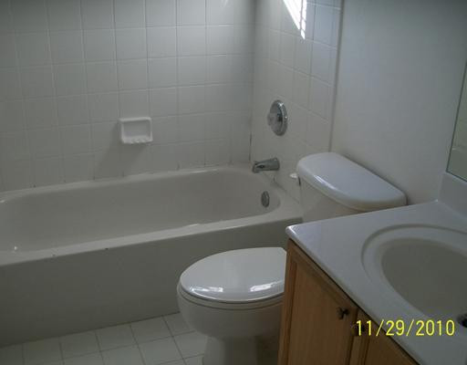 3345 Merrick Lane, Unit 1101 Margate, FL 33063 - Photo 7 of 9 a bathroom with a toilet a sink and bathtub