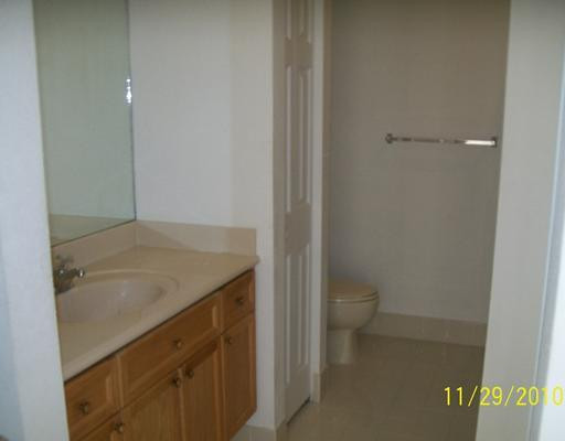 3345 Merrick Lane, Unit 1101 Margate, FL 33063 - Photo 8 of 9 a bathroom with a granite countertop sink and a toilet