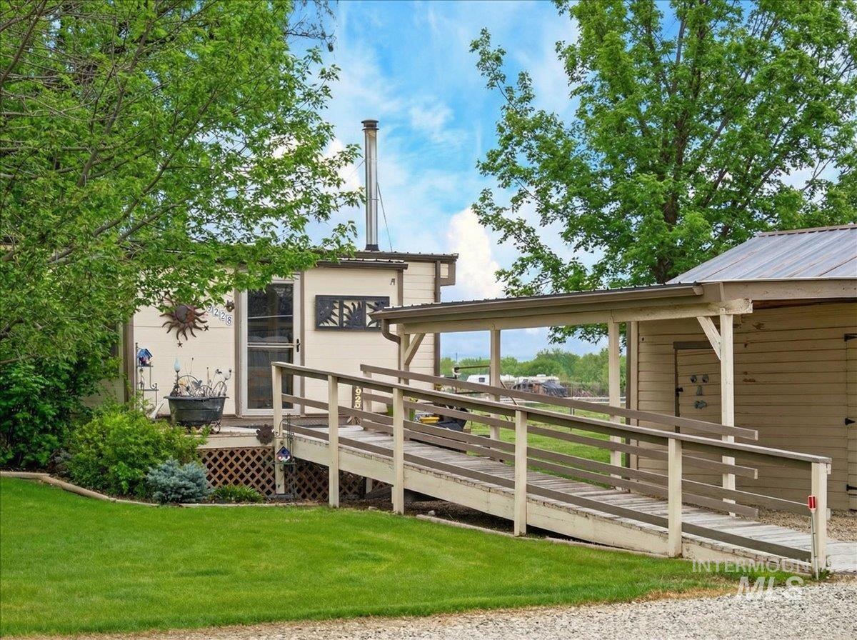 9228 Washoe Road Payette, ID 83661 - Photo 11 of 49 Back of property featuring a wooden deck and a yard