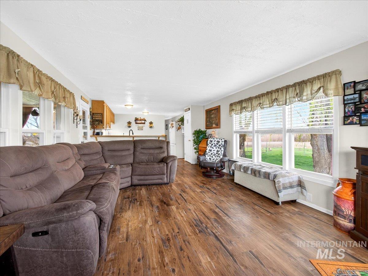 9228 Washoe Road Payette, ID 83661 - Photo 18 of 49 Living area featuring dark wood-style flooring and a textured ceiling