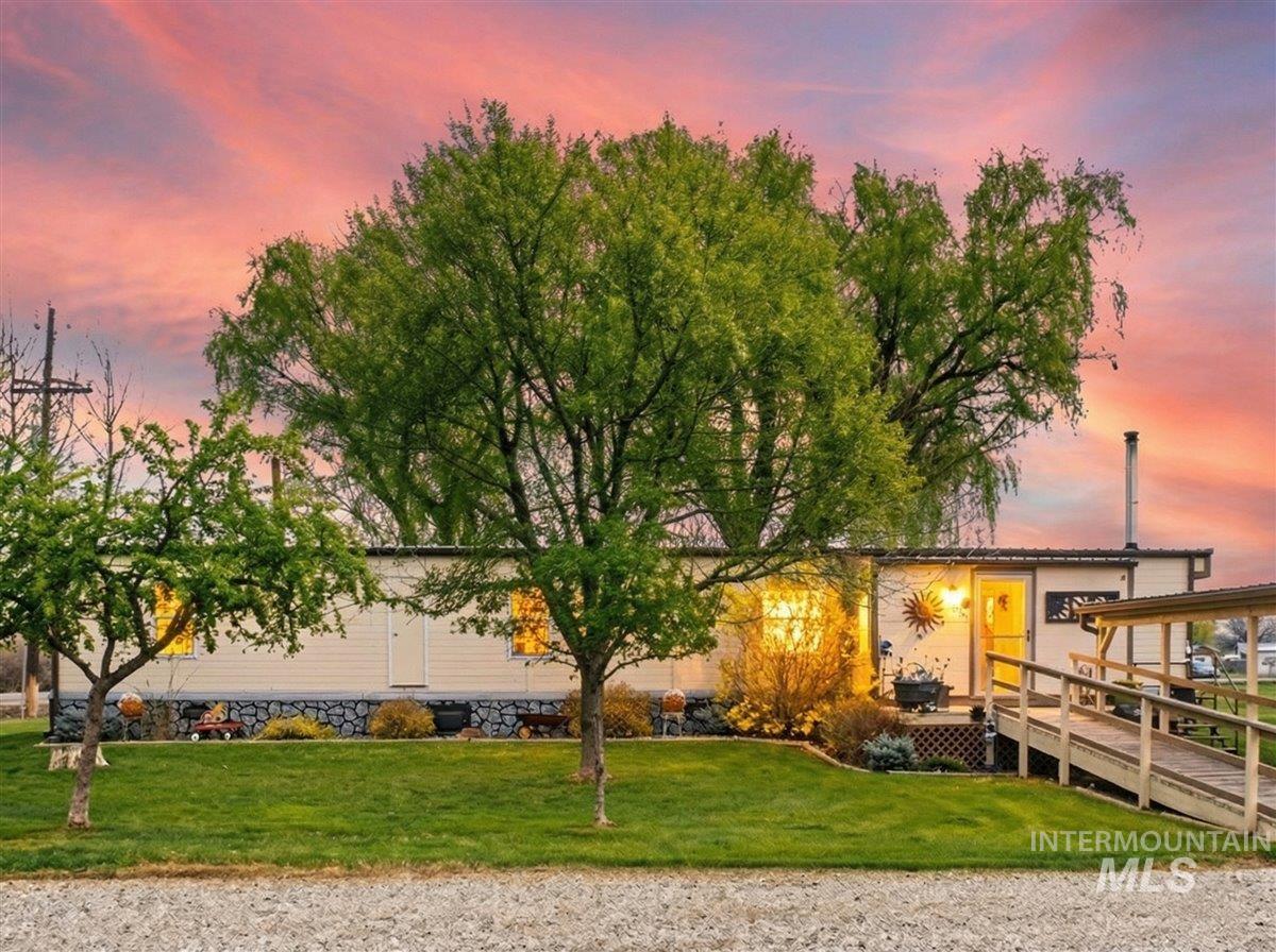 9228 Washoe Road Payette, ID 83661 - Photo 2 of 49 View of front of property with a front lawn and a wooden deck