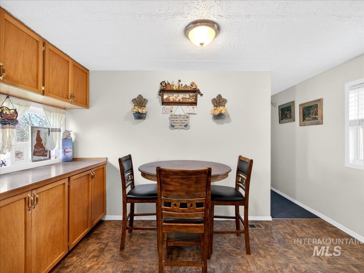 9228 Washoe Road Payette, ID 83661 - Photo 21 of 49 Dining space featuring plenty of natural light and a textured ceiling