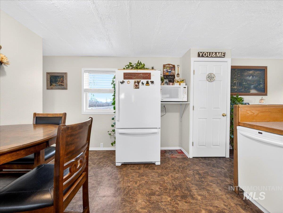 9228 Washoe Road Payette, ID 83661 - Photo 23 of 49 Kitchen with white appliances and a textured ceiling