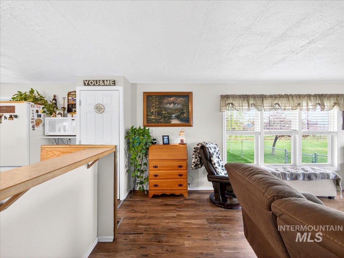 9228 Washoe Road Payette, ID 83661 - Photo 24 of 49 Living room featuring a textured ceiling and dark wood-type flooring