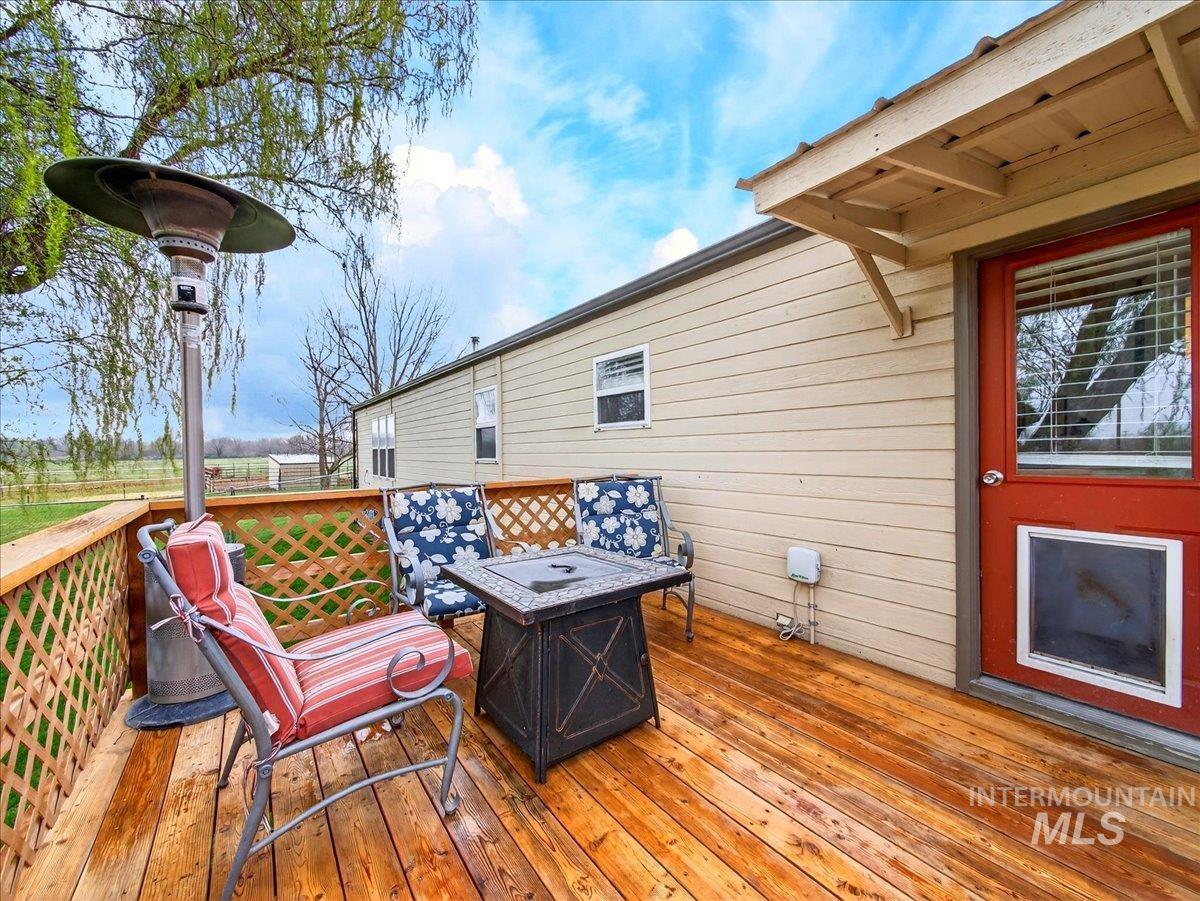 9228 Washoe Road Payette, ID 83661 - Photo 34 of 49 Wooden deck with a fire pit