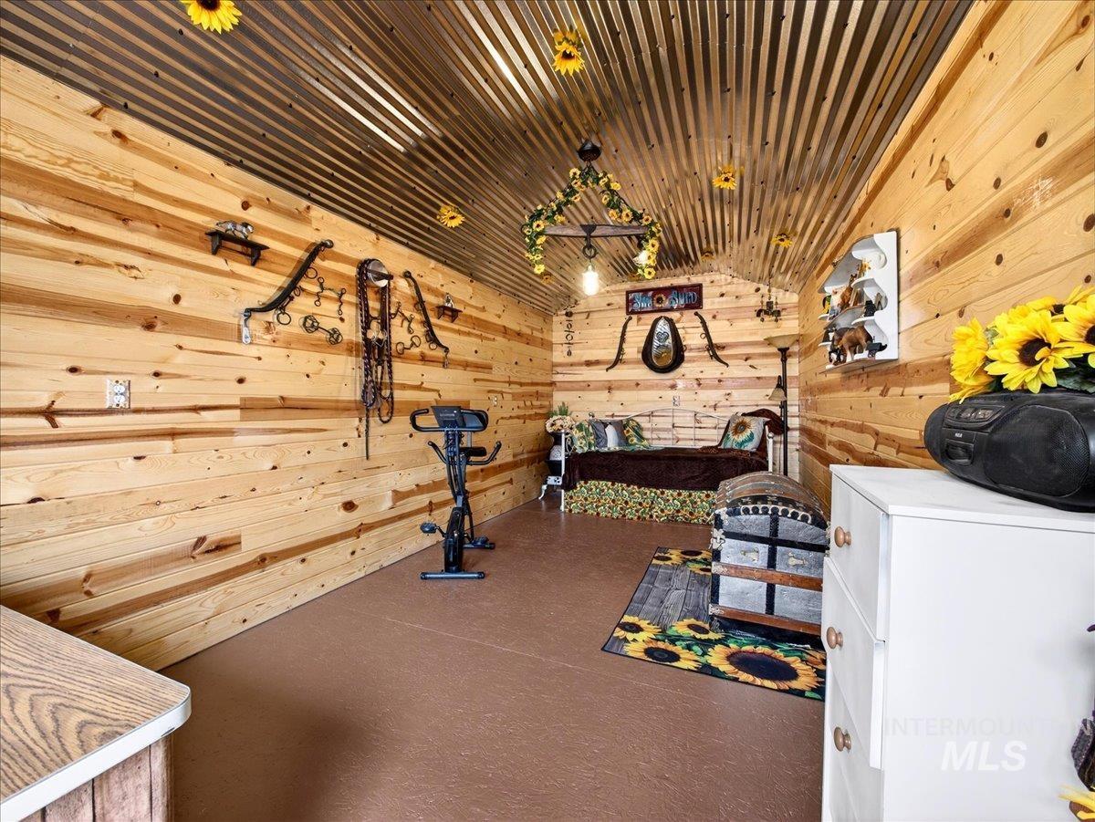 9228 Washoe Road Payette, ID 83661 - Photo 36 of 49 Playroom featuring lofted ceiling and wooden walls