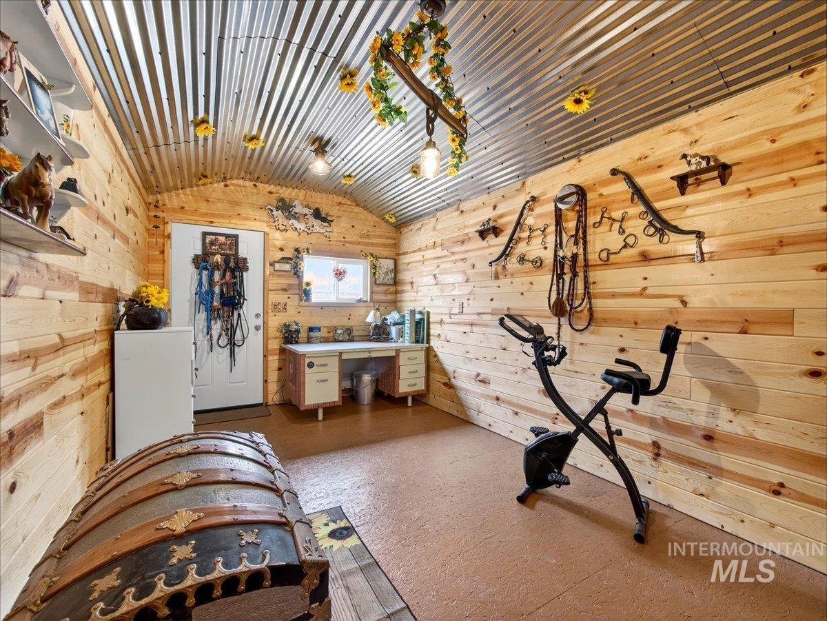 9228 Washoe Road Payette, ID 83661 - Photo 38 of 49 Workout room featuring vaulted ceiling and wooden walls