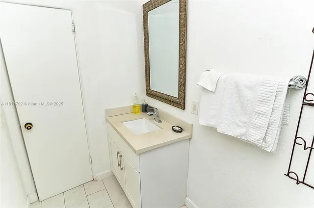 a bathroom with a sink a mirror and shower