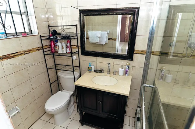 a bathroom with a sink toilet and mirror