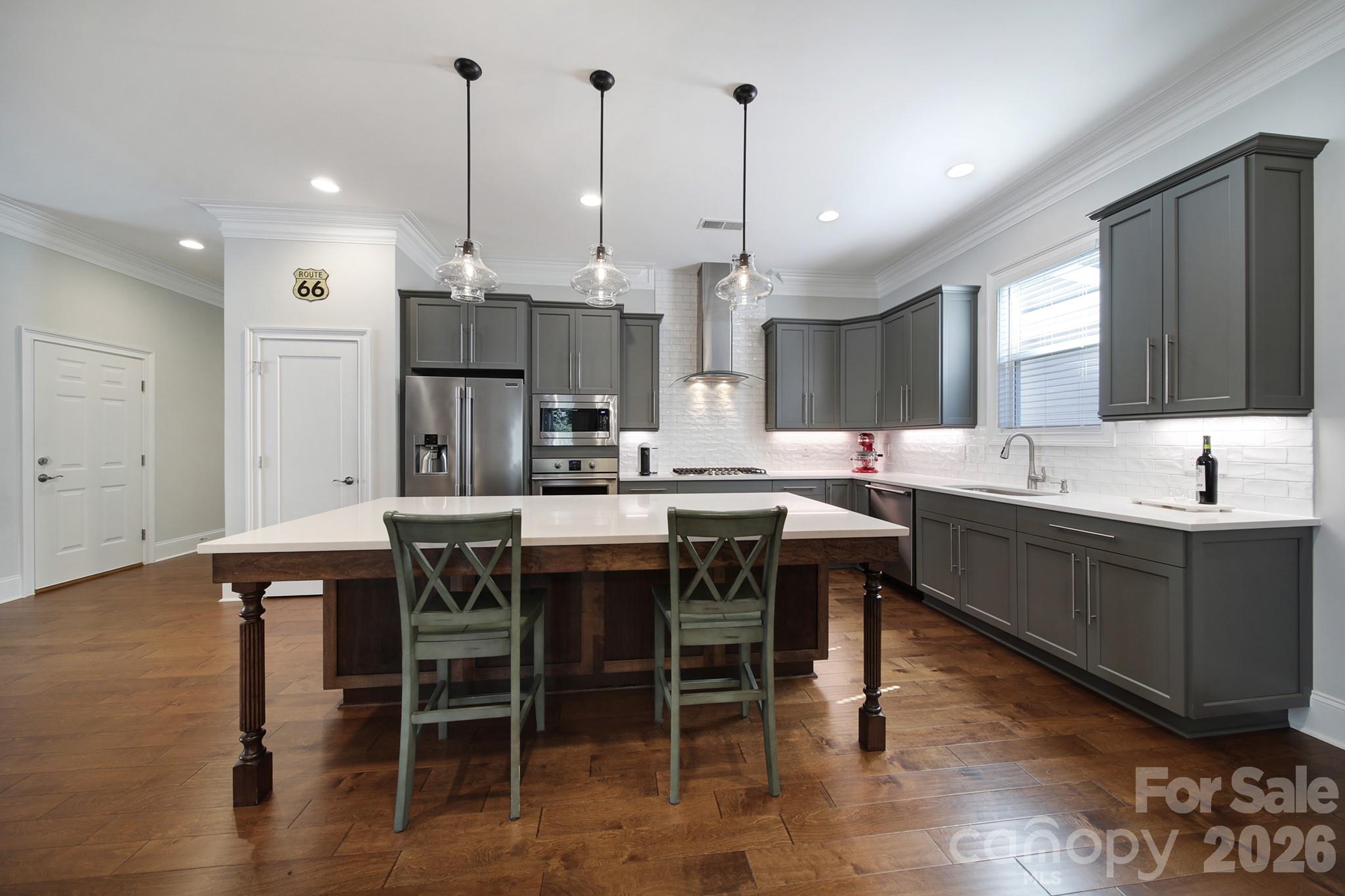 1633 Half Pint Loop Fort Mill, SC 29708 - Photo 11 of 48 a kitchen with kitchen island a sink table and chairs