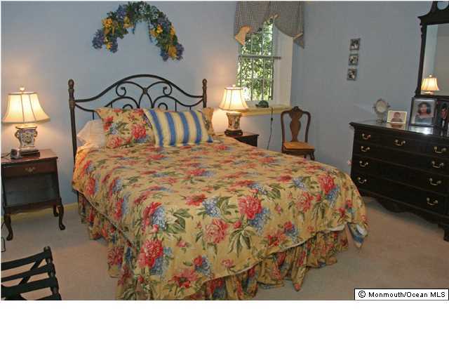 268 Pelican Road Middletown, NJ 07748 - Photo 16 of 21 a bedroom with a bed and a mirror on the dresser