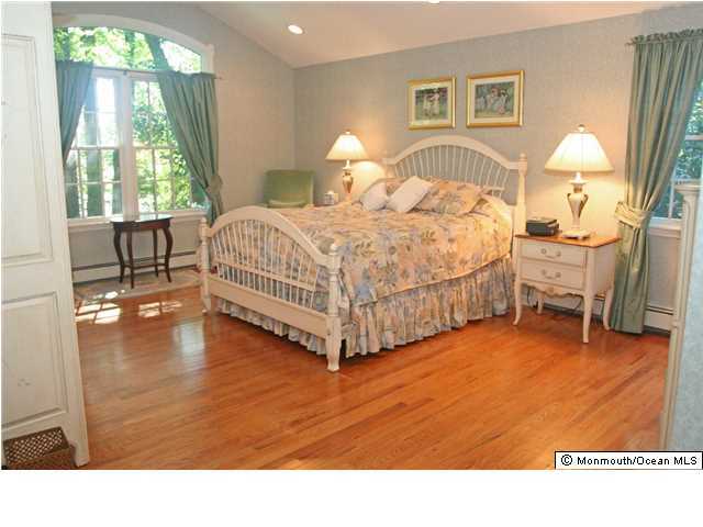 268 Pelican Road Middletown, NJ 07748 - Photo 10 of 21 a bedroom with a bed and a table in it