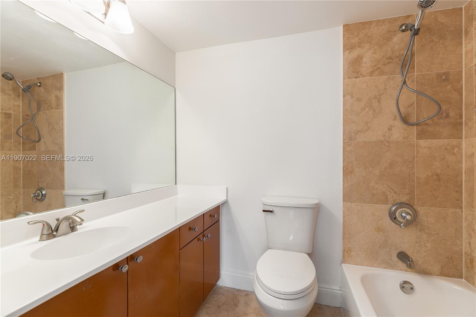 1621 Bay Road, Unit 604 Miami Beach, FL 33139 - Photo 12 of 30 a bathroom with a sink toilet vanity and shower