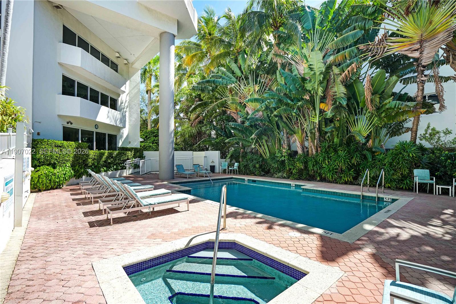 1621 Bay Road, Unit 604 Miami Beach, FL 33139 - Photo 22 of 30 a view of a patio with a table and chairs under an umbrella