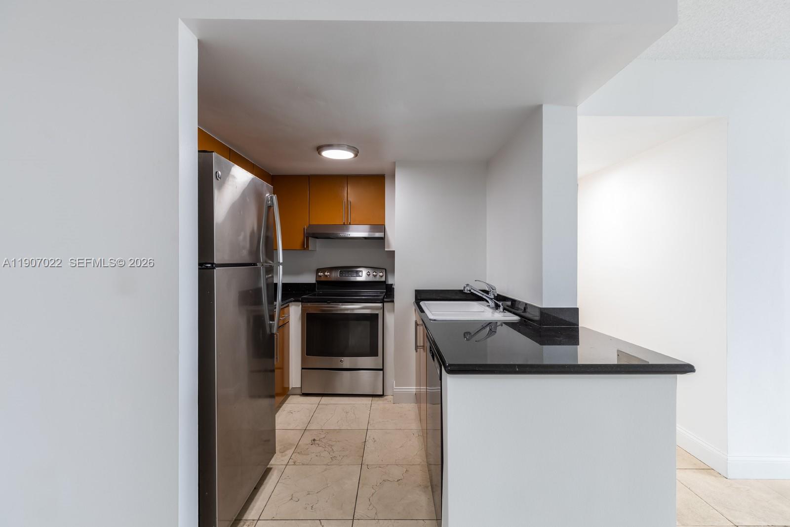 1621 Bay Road, Unit 604 Miami Beach, FL 33139 - Photo 6 of 30 a kitchen with a refrigerator and a stove