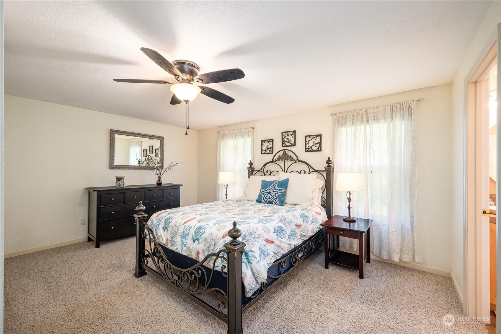 405 Viewcrest Road Bellingham, WA 98229 - Photo 17 of 36 a bedroom with a bed and a chandelier