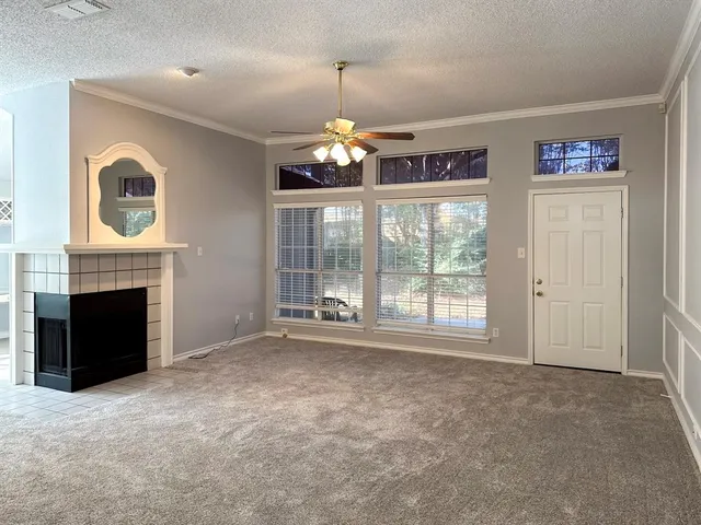 a view of a livingroom with an empty space and a fireplace