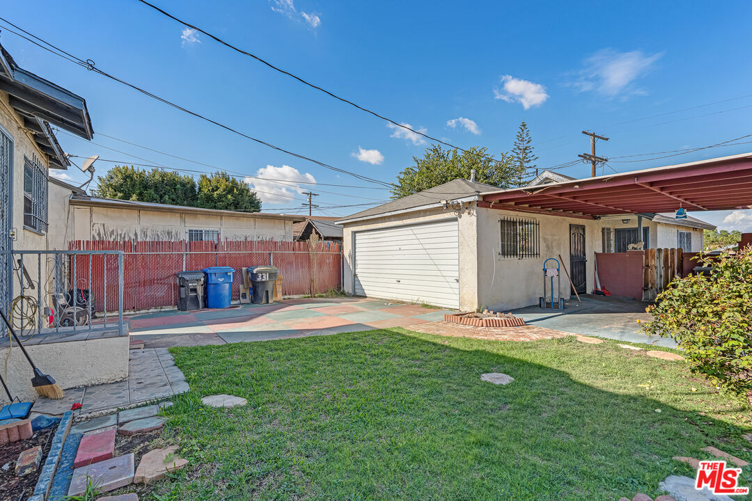 331 East 119th Street Los Angeles, CA 90061 - Photo 23 of 40 a backyard of a house with table and chairs
