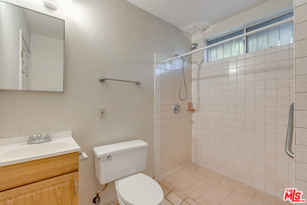 331 East 119th Street Los Angeles, CA 90061 - Photo 34 of 40 a bathroom with a shower a toilet and a sink